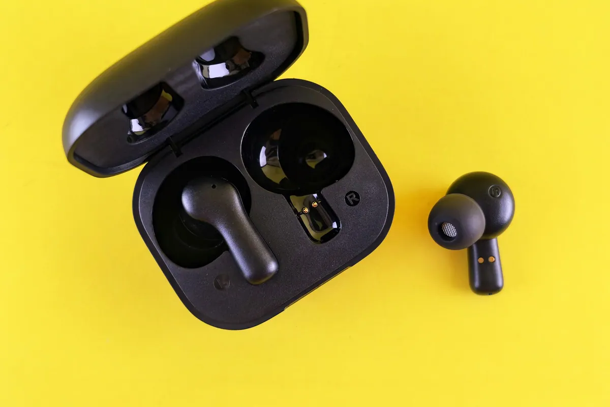 Black wireless earbuds with their open charging case